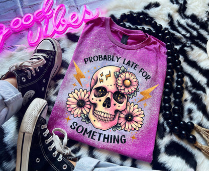 A Berry pink t-shirt with a bleached effect featuring a skull with flowers and the text "Probably Late For Something" in gold glitter.