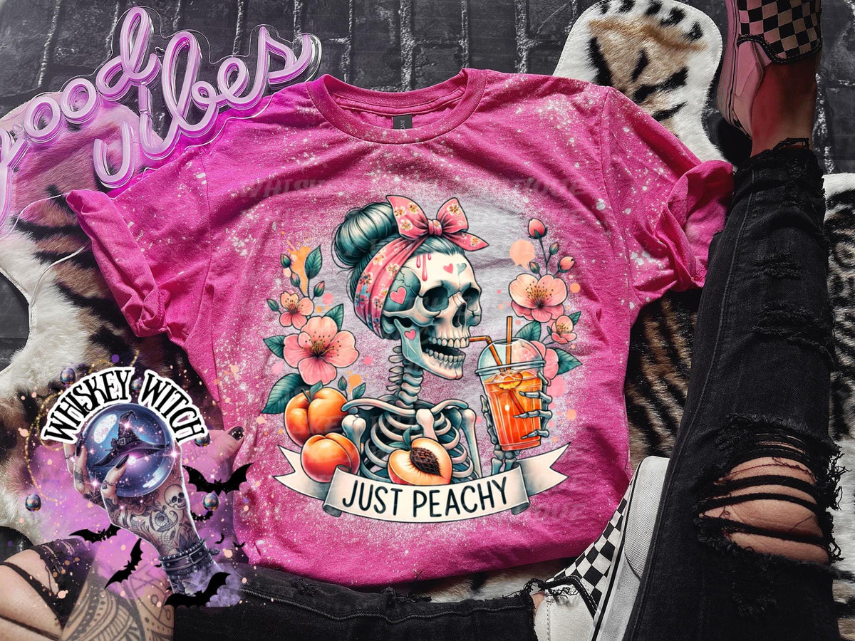 Pink tie-dye t-shirt with a skeleton wearing a bandana and drinking a glass of orange juice. The text "Just Peachy" is printed on the shirt.Just Peachy Skeleton Shirt, Hand Bleached Peach Tee, Spooky Cute Summer Graphic T-Shirt, Gildan Unisex