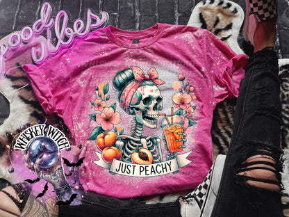 Pink tie-dye t-shirt with a skeleton wearing a bandana and drinking a glass of orange juice. The text "Just Peachy" is printed on the shirt.Just Peachy Skeleton Shirt, Hand Bleached Peach Tee, Spooky Cute Summer Graphic T-Shirt, Gildan Unisex