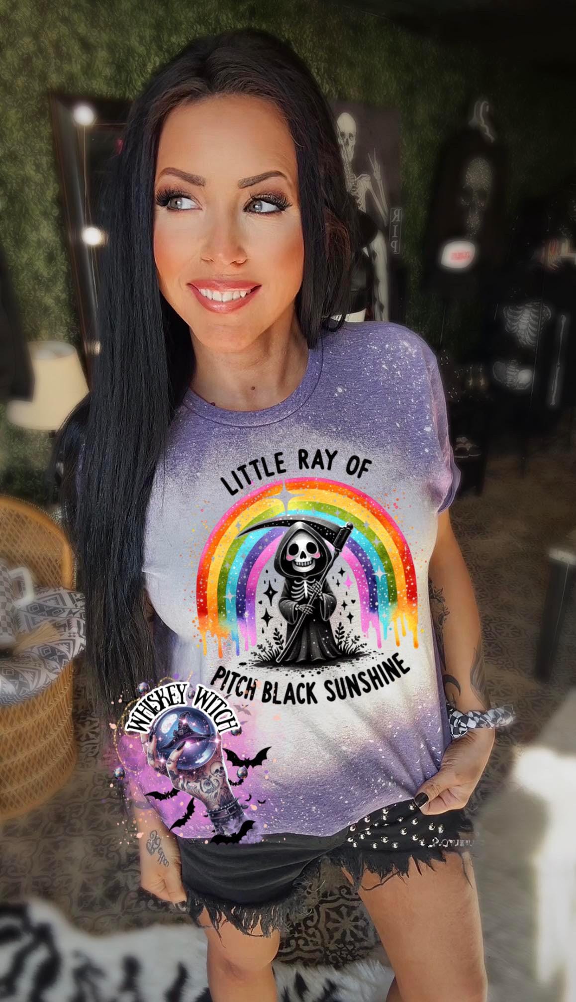 Close-up of bleach-wash tee showing dripping rainbow over a skeleton reaper holding a scythe with “Pitch Black Sunshine” text.