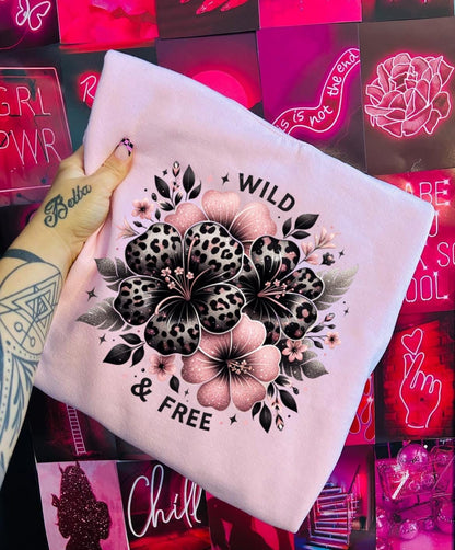 Light pink unisex sweatshirt with ‘Wild & Free’ leopard floral hibiscus graphic in black and pink