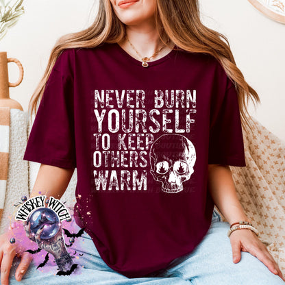 Close-up of white ink skull and rough text on self-care boundaries shirt