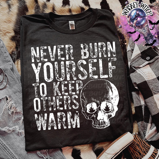 Close-up of white ink skull and rough text on self-care boundaries shirt