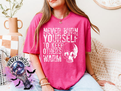Close-up of white ink skull and rough text on self-care boundaries shirt