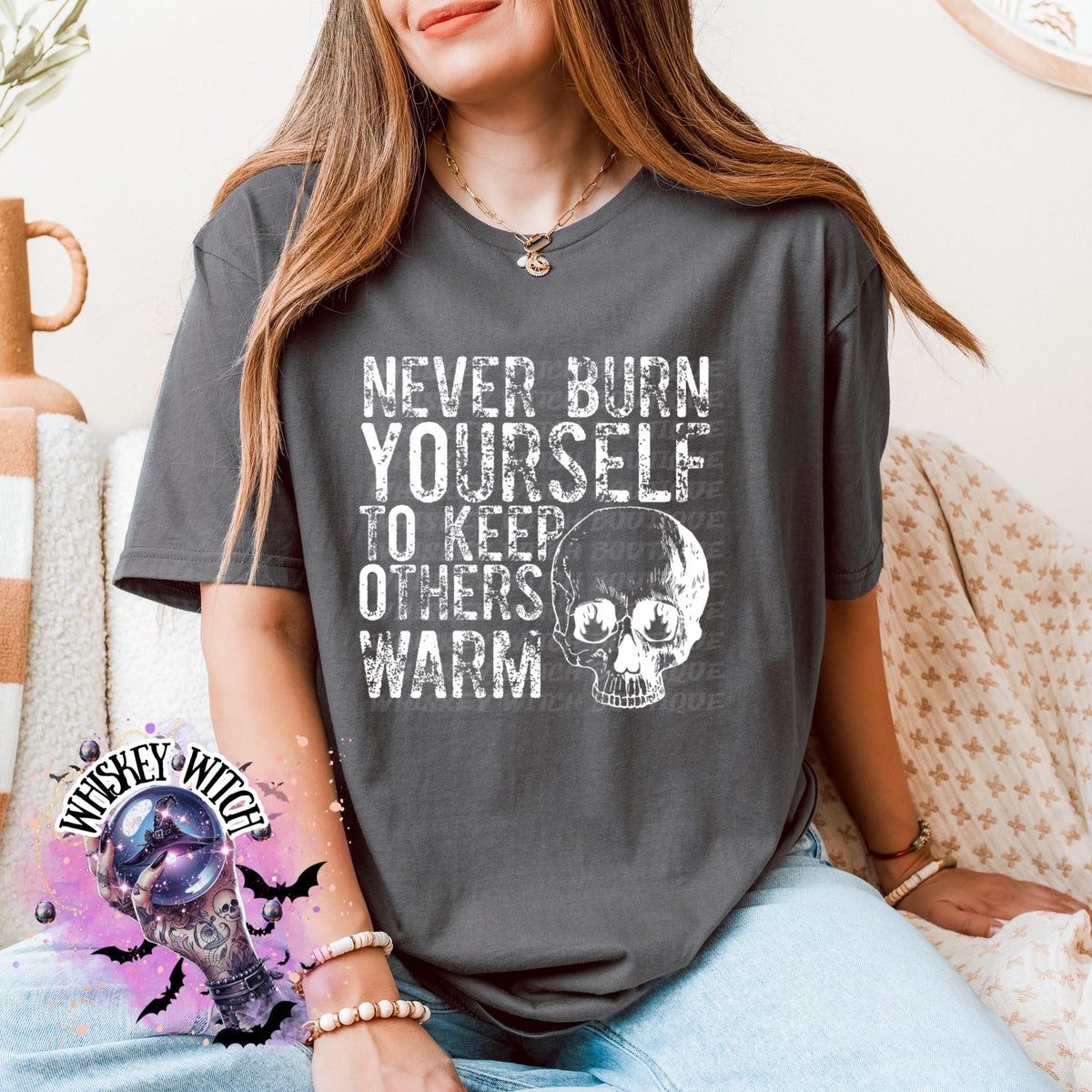 Close-up of white ink skull and rough text on self-care boundaries shirt