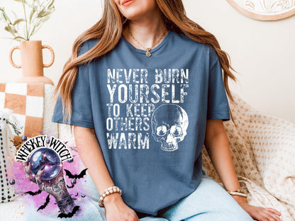 Close-up of white ink skull and rough text on self-care boundaries shirt