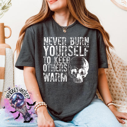 Close-up of white ink skull and rough text on self-care boundaries shirt