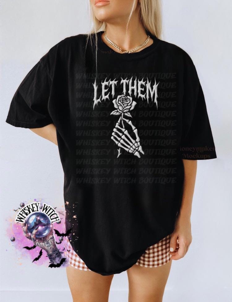 Black oversized t-shirt with the text "LET THEM" in a gothic font, and a skeleton hand holding a rose.