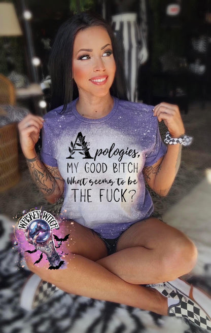 A purple t-shirt with a bleached design and the text "Apologies, MY GOOD BITCH What seems to be THE FUCK?". The shirt has a round neck and short sleeves.