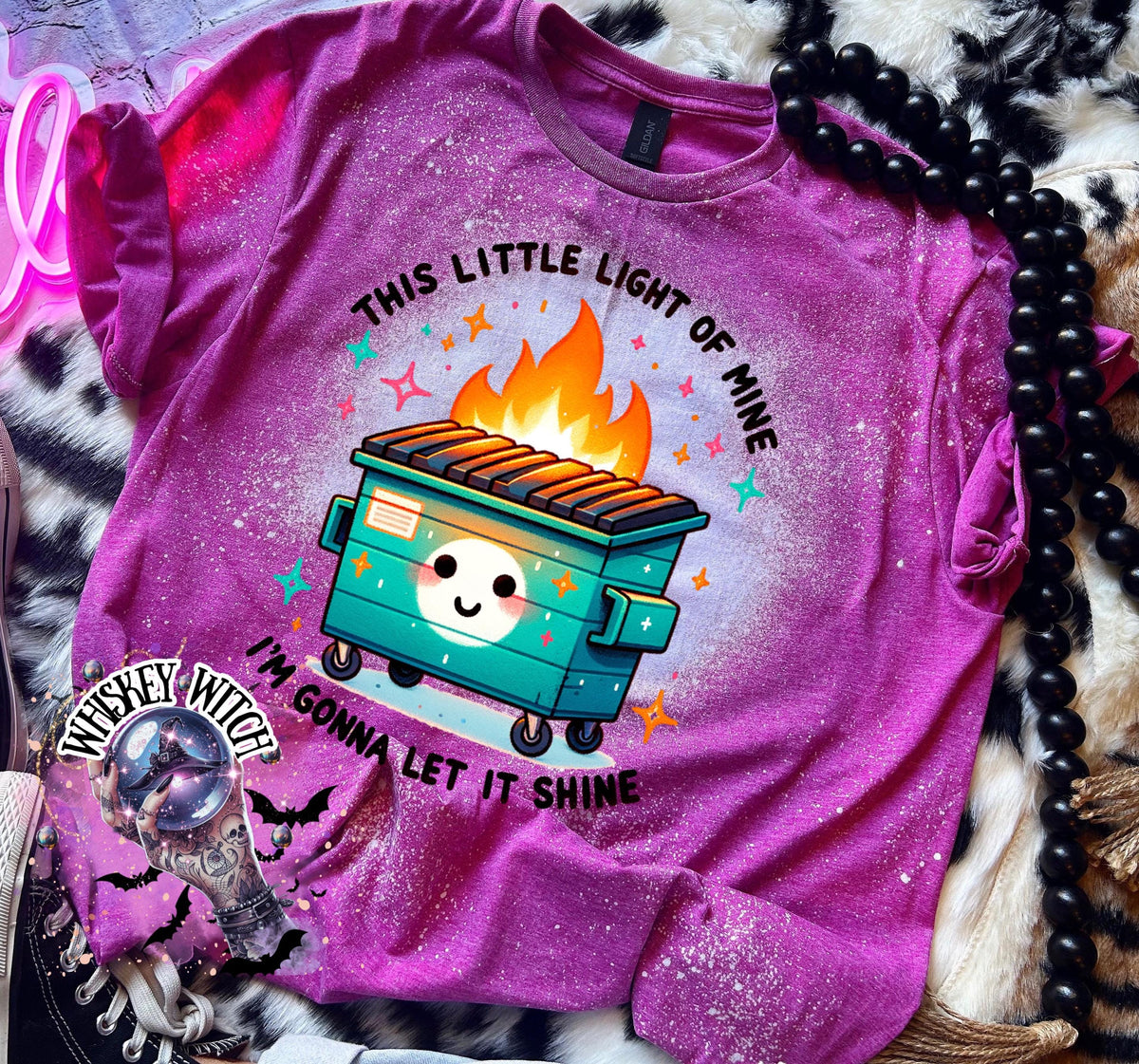 Berry Pink t-shirt with a bleach-splattered design featuring a cartoon dumpster on fire with the text "This little light of mine I'm gonna let it shine".