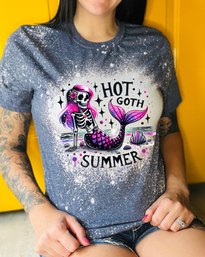 A navy t-shirt with a bleach-splattered design featuring a pink and purple skeleton mermaid with the text "Hot Goth Summer".