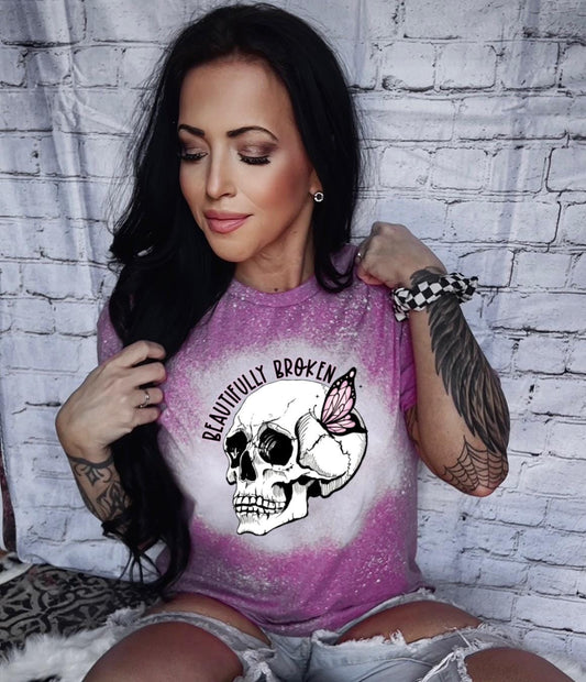 Berry bleached t-shirt with a white skull and butterfly graphic. The text "Beautifully Broken" is printed above the skull.