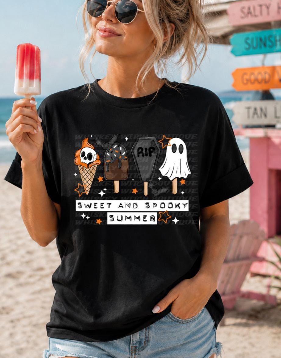 Black graphic tee with Sweet and Spooky Summer lettering and Halloween-inspired summer treats.
Flat lay photo of handmade spooky summer tee with orange, white, gray, and black design.