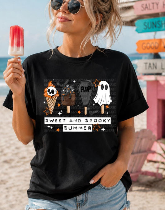 Black graphic tee with Sweet and Spooky Summer lettering and Halloween-inspired summer treats.
Flat lay photo of handmade spooky summer tee with orange, white, gray, and black design.