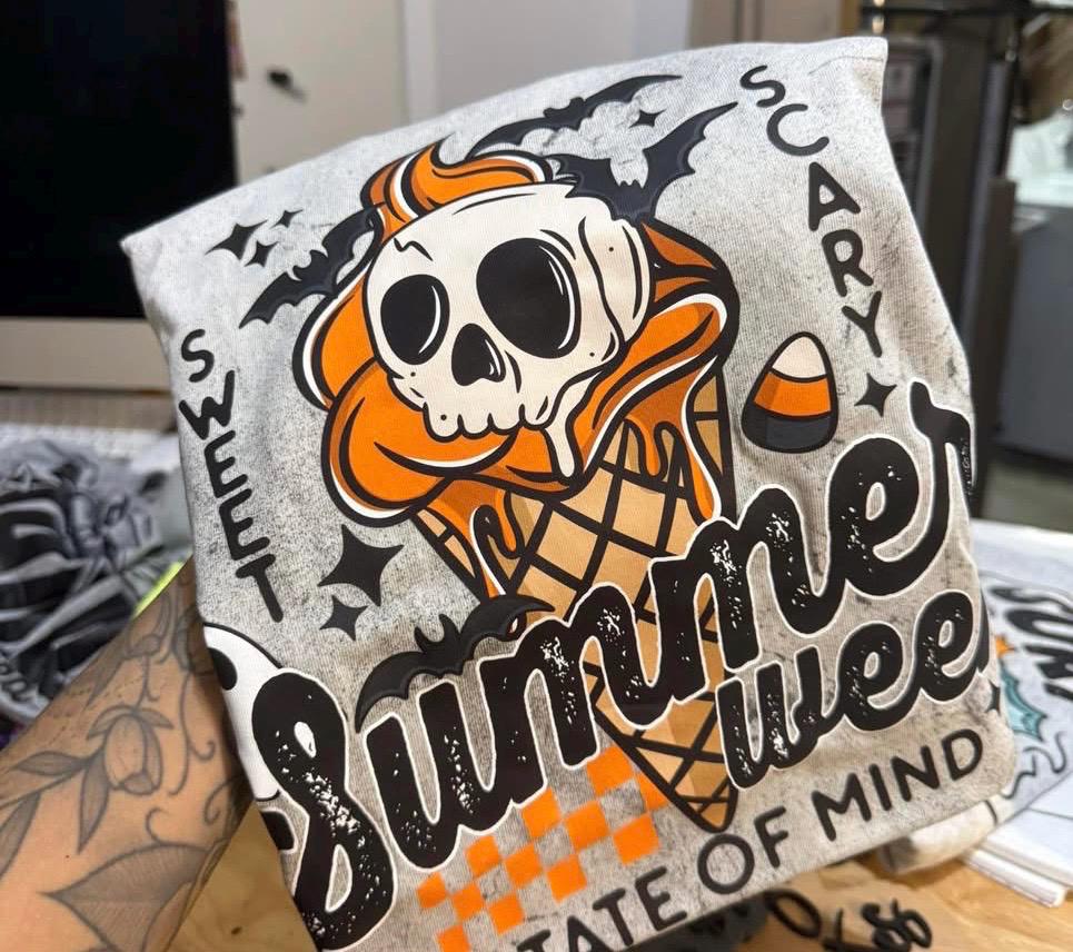 Handmade goth summer vacation tee featuring ghost, ice cream cone, and Halloween-inspired details.
Gray Summerween graphic T-shirt styled for a beach day with spooky cute design.
