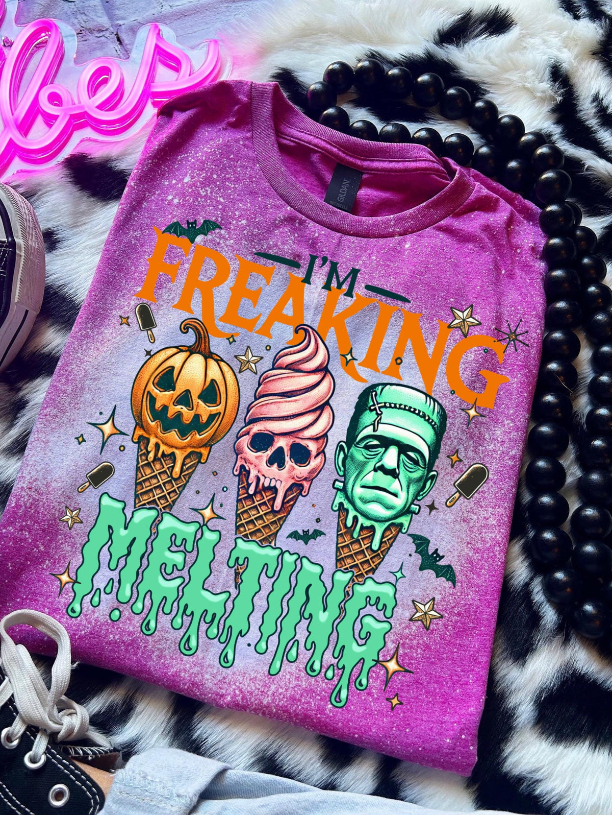 Spooky summer graphic tee featuring pumpkin, skull, and Frankenstein ice cream cones with bright orange and green lettering.