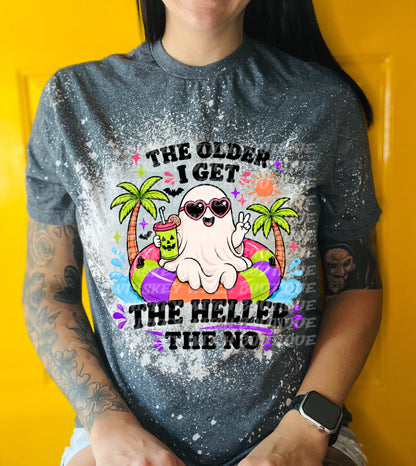A gray t-shirt with a bleached design featuring a cartoon ghost wearing sunglasses and a pool float. The text reads "THE OLDER I GET THE HELLER THE NO". The ghost is holding a drink.