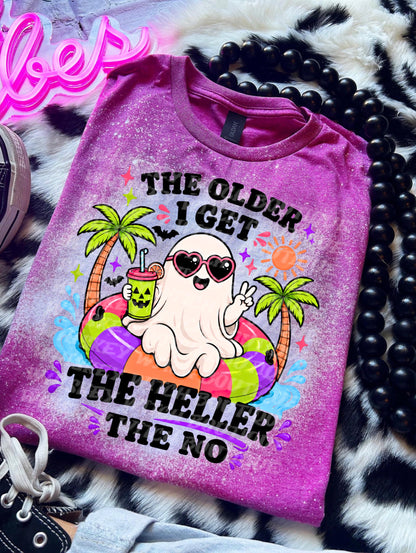 bleached handmade T-shirt with a cute ghost on a colorful pool floatie, palm trees, sunglasses, and funny black text reading The Older I Get The Heller The No.
